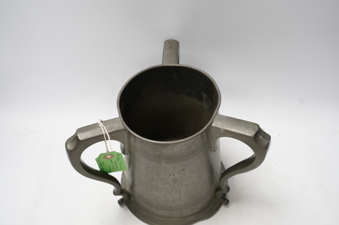 A 19th century pewter three handled rowing trophy from Caius College, 19cm. Condition - fair